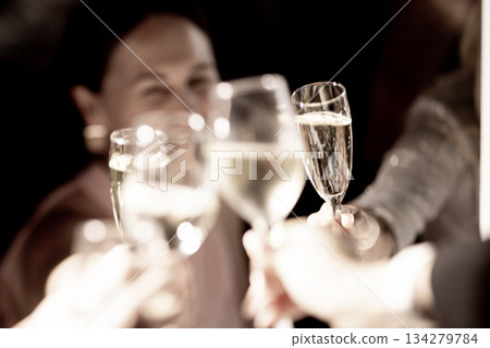 Celebration of New Year with people clinking glasses at festive event 134279784