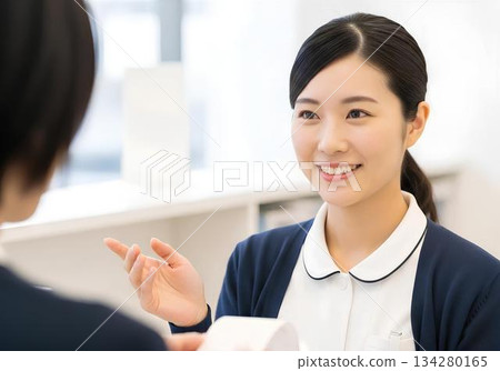 Smiling female receptionist at medical office - A reassuring image of medical care welcoming patients 134280165