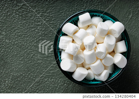 White Marshmallows in Turquoise Bowl on Green Textured Surface Top View Copy Space White Marshmallows in Turquoise Bowl on Green Textured Surface Top View Copy Space 134280404