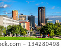 Downtown Saint Paul skyline rises beyond the green lawns of the Minnesota State Capitol Mall. View features Wells Fargo Place and government buildings under a blue summer sky 134280498