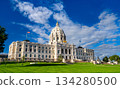 Minnesota State Capitol building stands in Saint Paul, USA. Renaissance Revival architecture features a white marble dome and golden quadriga statue under a blue sky 134280500