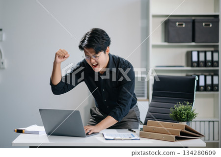 Asian businessman are delighted and happy with the work they do on their tablet, laptop Asian businessman are delighted and happy with the work they do on their tablet, laptop 134280609