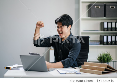 Asian businessman are delighted and happy with the work they do on their tablet, laptop Asian businessman are delighted and happy with the work they do on their tablet, laptop 134280610