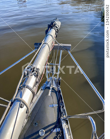 A beautiful view of a sailboat mast stands proudly over calm waters, showcasing natures serenity 134280692