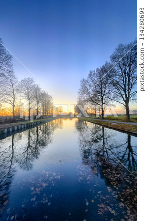 Tranquil Sunset Reflections on a Serene River, capturing the essence of a peaceful evening 134280693