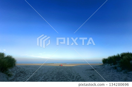 A Serene Beach Landscape featuring Beautiful Blue Skies and Gentle Ocean Waves at Peaceful Shores 134280696