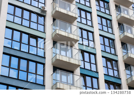 Contemporary city building, Modern residential tower featuring reflective windows and minimal design 134280738