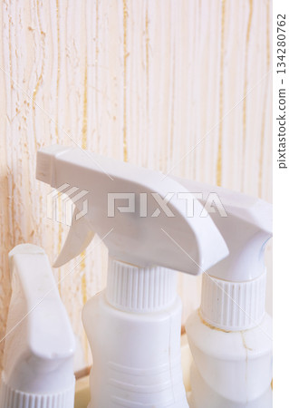 Unlabeled spray containers arranged tidily against textured surface with soft lighting Unlabeled spray containers arranged tidily against textured surface with soft lighting 134280762
