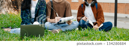 Young Asian People college students and a female student group work at the campus park in morning with her friend 134280884