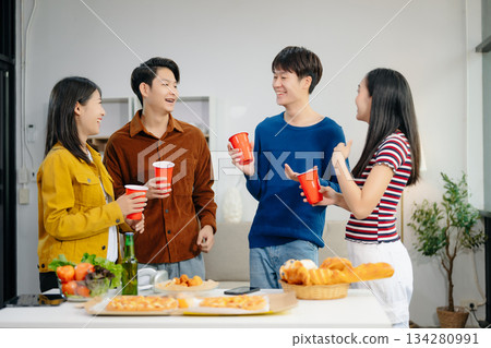 Young Asian friend having, enjoy evening party together at home. Attractive young man and woman having fun, eating food, celebrate at home 134280991
