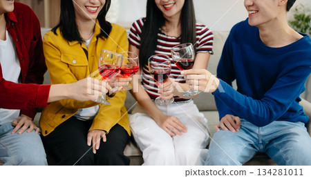 Young Asian friend having, enjoy evening party together at home. Attractive young man and woman having fun, eating food, celebrate at home Young Asian friend having, enjoy evening party together at home. Attractive young man and woman having fun, eating food, celebrate at home 134281011