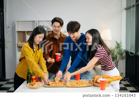 Young Asian friend having, enjoy evening party together at home. Attractive young man and woman having fun, eating food, celebrate at home 134281043