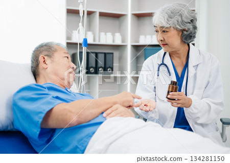 Medical doctor holing senior patient's hands and comforting her Medical doctor holing senior patient's hands and comforting her 134281150