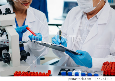 Doctor Talks With Professional Head Nurse or Surgeon, They Use Digital tablet Computer. Diverse Team of Health Care Specialists Discussing Test Doctor Talks With Professional Head Nurse or Surgeon, They Use Digital tablet Computer. Diverse Team of Health Care Specialists Discussing Test 134281208