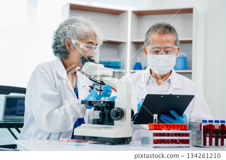 Scientist team meeting and writing analysis results in the laboratory study Scientist team meeting and writing analysis results in the laboratory study 134281210