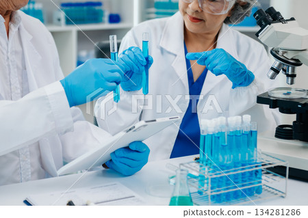 Scientist two woman with tablet and laptop, laboratory and ecofriendly science. Agriculture, research and scientists with online reading, test samples 134281286