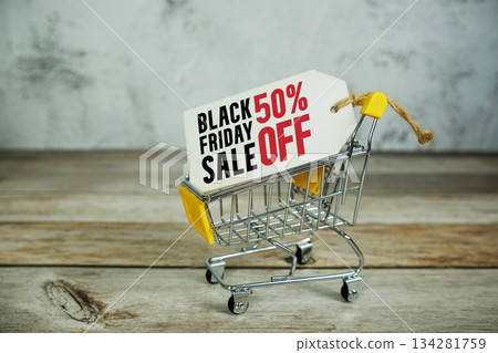 Black Friday Sale 50% off Limited time offer text with trolley shopping cart on pink background 134281759