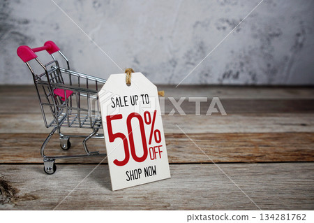 Sale 50% off text with trolley shopping cart on wooden background 134281762