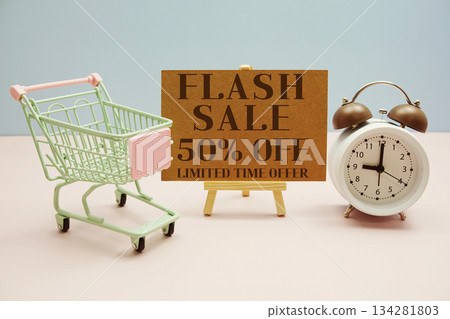 Flash Sale 50% off Limited time offer text with trolley shopping cart and alarm clock on pink background 134281803