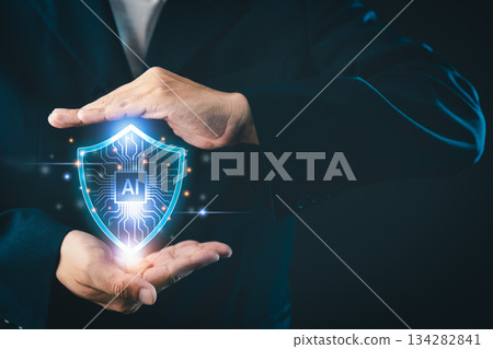 Businessman protects artificial intelligence with a glowing shield symbol, representing AI security, data protection, and advanced technology in a digital environment Businessman protects artificial intelligence with a glowing shield symbol, representing AI security, data protection, and advanced technology in a digital environment 134282841