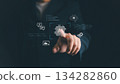 Businessman touching AI icon on virtual screen, symbolizing artificial intelligence, machine learning, digital technology, automation, innovation, and future data-driven business solutions. 134282860
