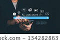 Modern concept of AI assistant with business person using smartphone and virtual interface icons. Innovation, artificial intelligence, and digital technology for smart communication 134282863