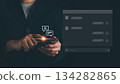Businessman using smartphone with glowing AI chatbot interface, representing artificial intelligence, virtual assistant, online communication, customer support automation, Future digital technology 134282865