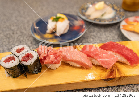 擺放在木製壽司涼鞋上的各種鮪魚壽司 擺放在木製壽司涼鞋上的各種鮪魚壽司 134282963