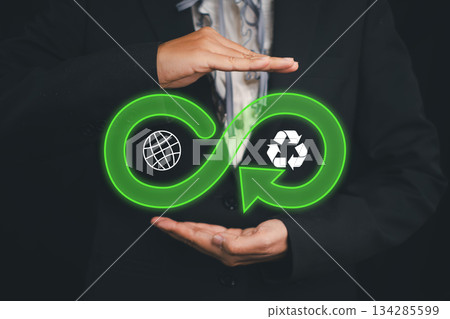 Visual representation of the circular economy with infinity and recycling symbols, promoting sustainability and eco-friendly practices. Visual representation of the circular economy with infinity and recycling symbols, promoting sustainability and eco-friendly practices. 134285599