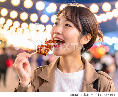 年輕女子吃烤串 134286463
