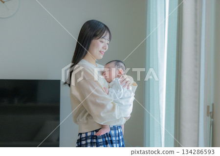 Woman holding a baby 134286593