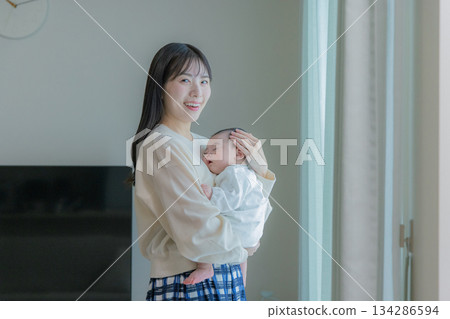 Woman holding a baby 134286594