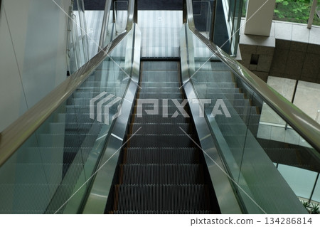 Down escalator in a building 134286814
