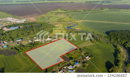 A piece of land, encompassing a view from above, a specific point on the ground, and a line that marks its boundaries. This land can be purchased, sold, developed, rented, or invested in. A piece of land, encompassing a view from above, a specific point on the ground, and a line that marks its boundaries. This land can be purchased, sold, developed, rented, or invested in. 134286887