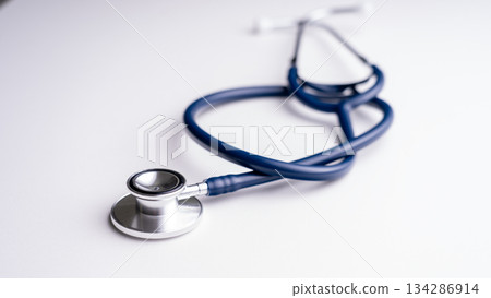 Stethoscope medical tool. A medical instrument is a stethoscope on a white background, shooting at an acute angle. Therapist's tool for patient diagnosis 134286914