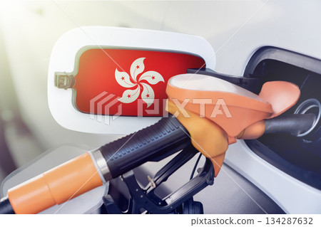 Hong Kong flag on the lid of the gas tank of a car at a gas station in close-up. High or low gasoline prices at Hong Kong gas stations. gasoline prices are rising due to a shortage of diesel fuel. 134287632