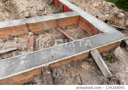 Rugged building site showcasing a concrete foundation formwork set Rugged building site showcasing a concrete foundation formwork set 134288091