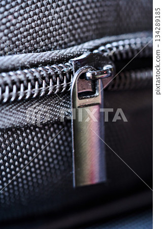 Close view of a zipper on black fabric Close view of a zipper on black fabric 134289185