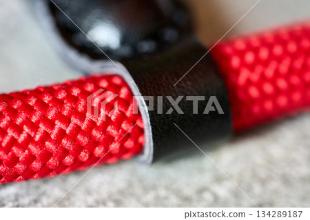 Close up of red rope with a black strap Close up of red rope with a black strap 134289187