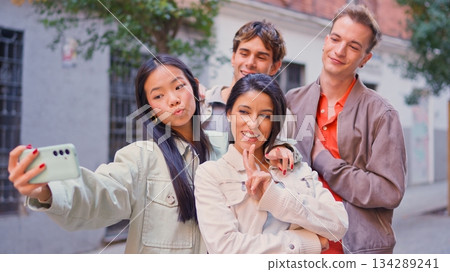 Diverse friends taking inclusive street selfie together 134289241
