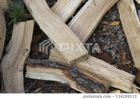 Chopped wood lying on the ground 134289513