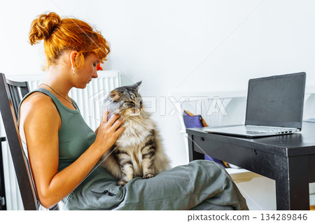young woman spends time with her pet cat 134289846