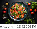 flat lay tomatoes with basil parmesan cheese on plate on black background 134290356
