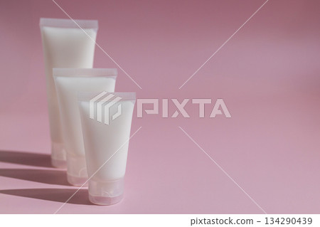 Minimalist skincare mockup with blank cosmetic tubes on soft pink background, perfect for beauty branding, product design, packaging presentation and modern cosmetics advertising. Minimalist skincare mockup with blank cosmetic tubes on soft pink background, perfect for beauty branding, product design, packaging presentation and modern cosmetics advertising. 134290439