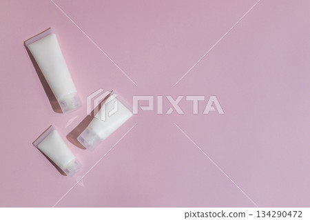 Minimalist skincare mockup with blank cosmetic tubes on soft pink background, perfect for beauty branding, product design, packaging presentation and modern cosmetics advertising. Minimalist skincare mockup with blank cosmetic tubes on soft pink background, perfect for beauty branding, product design, packaging presentation and modern cosmetics advertising. 134290472