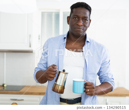 man enjoying morning coffee at home kitchen man enjoying morning coffee at home kitchen 134290515