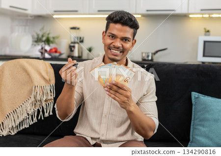 Indian man counts euro cash happy makes money gesture plans dream purchase savings bonus invest plan Indian man counts euro cash happy makes money gesture plans dream purchase savings bonus invest plan 134290816