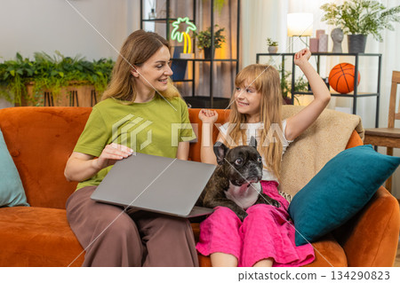 Mother daughter dog finish on laptop close project relief press submit celebrate success together Mother daughter dog finish on laptop close project relief press submit celebrate success together 134290823