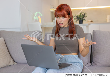 Young woman frustrated at laptop app crash virus glitch error freezes work causes despair and stress 134290827