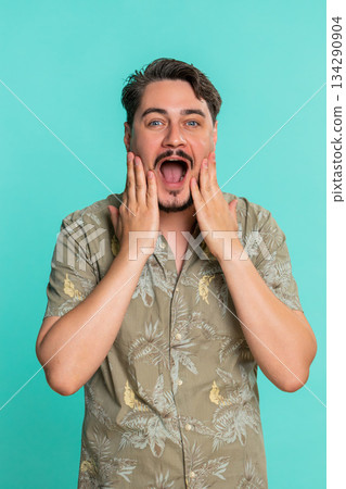 Adult man opens mouth shocked by unexpected win or success showing wow emotion with amazed reaction Adult man opens mouth shocked by unexpected win or success showing wow emotion with amazed reaction 134290904